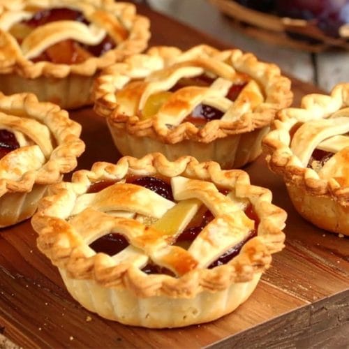 Treat-sized plum apple pies with flaky pastry