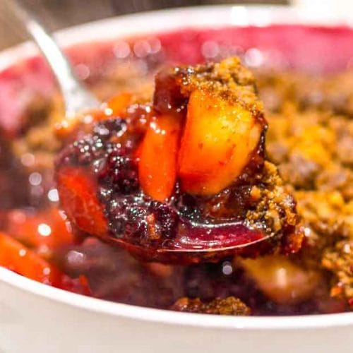 British crumble with plum and blackberry is on the bowl