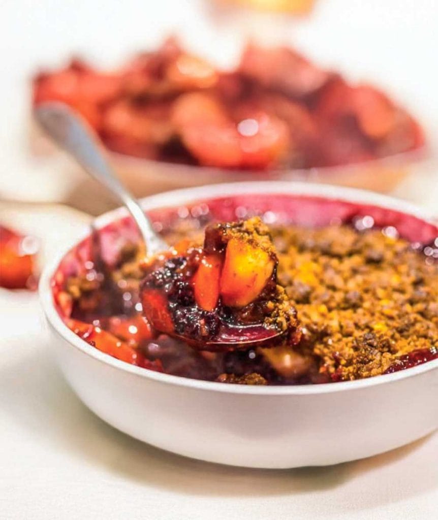 A bowl of plum and blackberry crumble