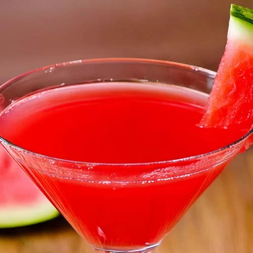 Watermelon martini is garnished with a small watermelon wedge.