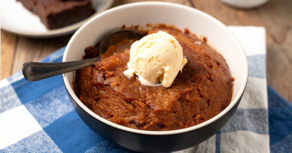 Baked Indian Pudding topped with vanilla ice cream