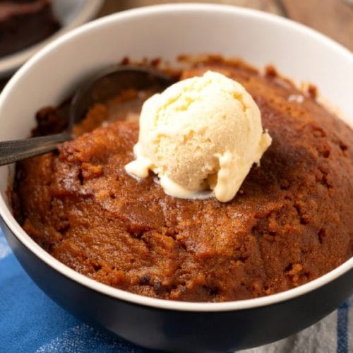 Baked Indian Pudding topped with vanilla ice cream
