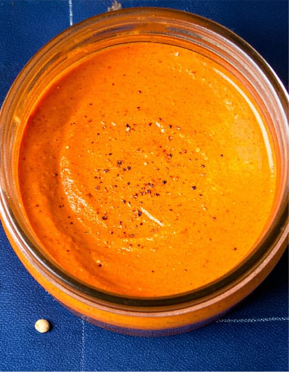 A jar of roasted red pepper dressing with red bell pepper