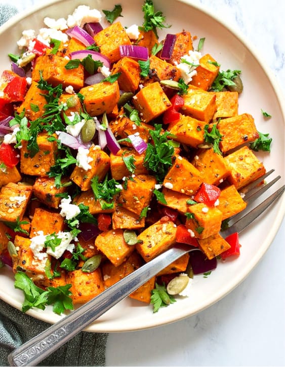 Sweet potato salad mix with bell peppers, feta, parsley, and red onion