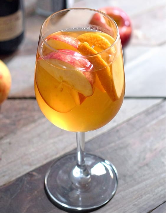 Best apple cider sangria, with white wine, apple slices, orange slices and cinnamon
