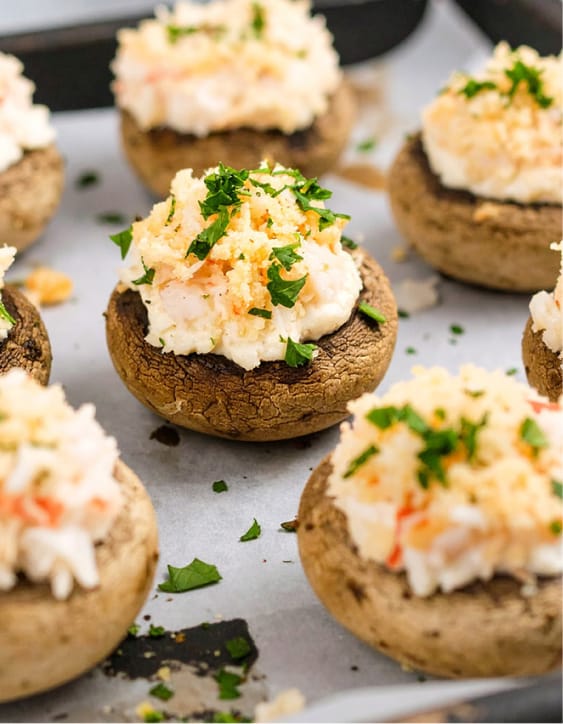 Easy crab-stuffed mushrooms topped with grated Parmesan cheese