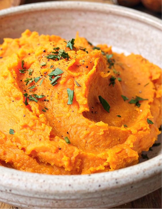 Easy mashed sweet potatoes, garnished with chopped herbs