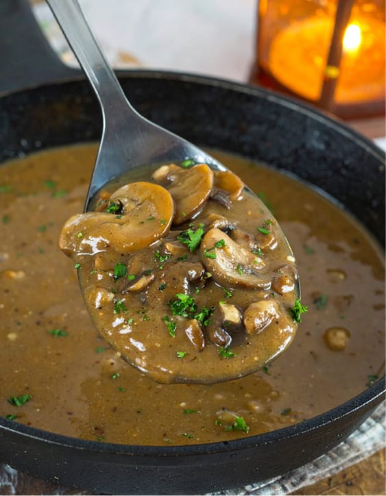 Thick mushroom gravy garnished with chopped parsley