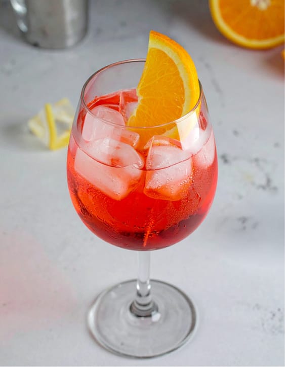 Campari spritz garnished with an orange slice