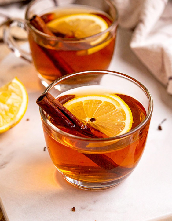 Hot toddy, garnish with a lemon slice, cinnamon stick