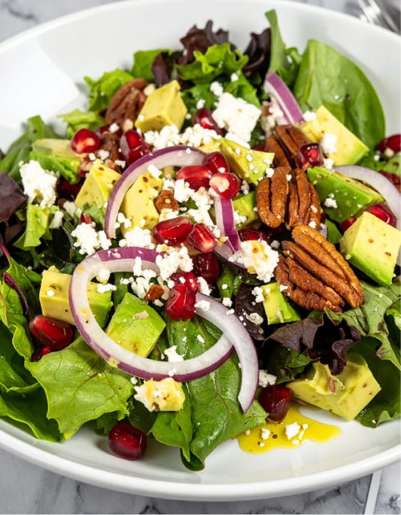 Pomegranate Salad with mixed greens, avocado, nuts and feta cheese