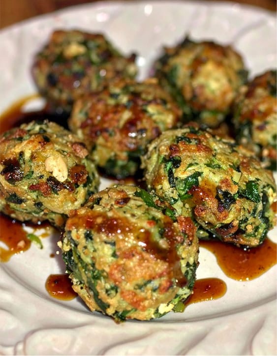 Easy baked spinach balls drizzled with teriyaki sauce